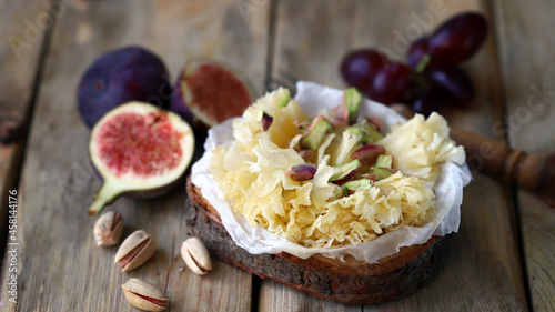 Cheese tet de moine with figs and pistachios. photo