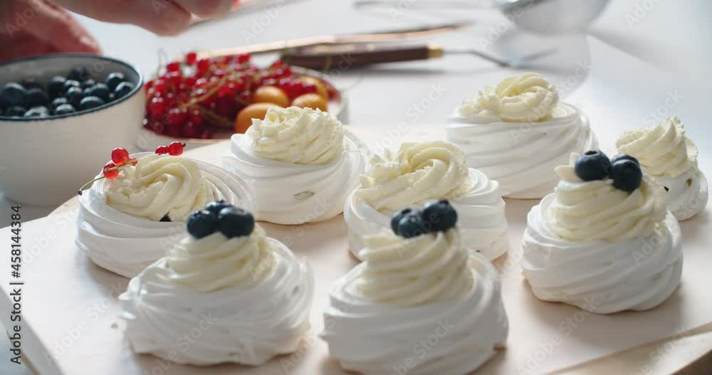 Cake Pavlova. The process of making a cake Pavlova. The pastry chef decorates the cake Anna Pavlova. Making a cake Anna Pavlova. High quality 4k footage
