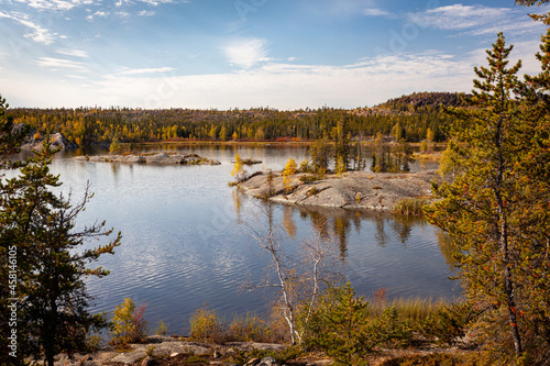 Photo of a lake near Yellowknife Canada on a beautiful, calm fall afternoon with reflections in the water  © HJ