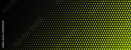 Abstract halftone background made of small hexagonal dots of different sizes in yellow and black colors