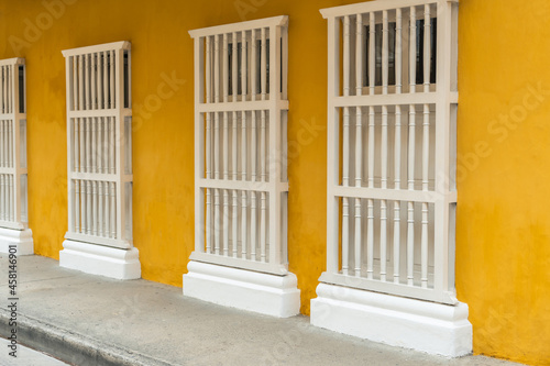 Yellow wall with wooden windows