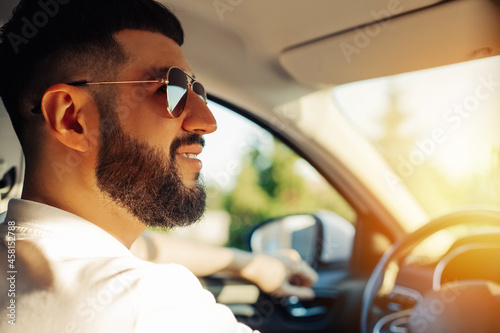 Male driver, buying a new car, making a test drive, choosing a new car in a car dealership