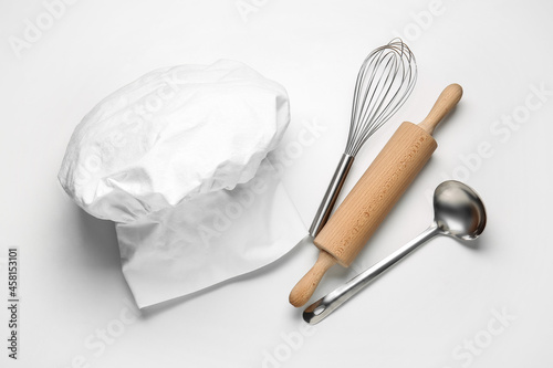 Fototapeta Naklejka Na Ścianę i Meble -  Chef's hat and kitchen utensils on white background