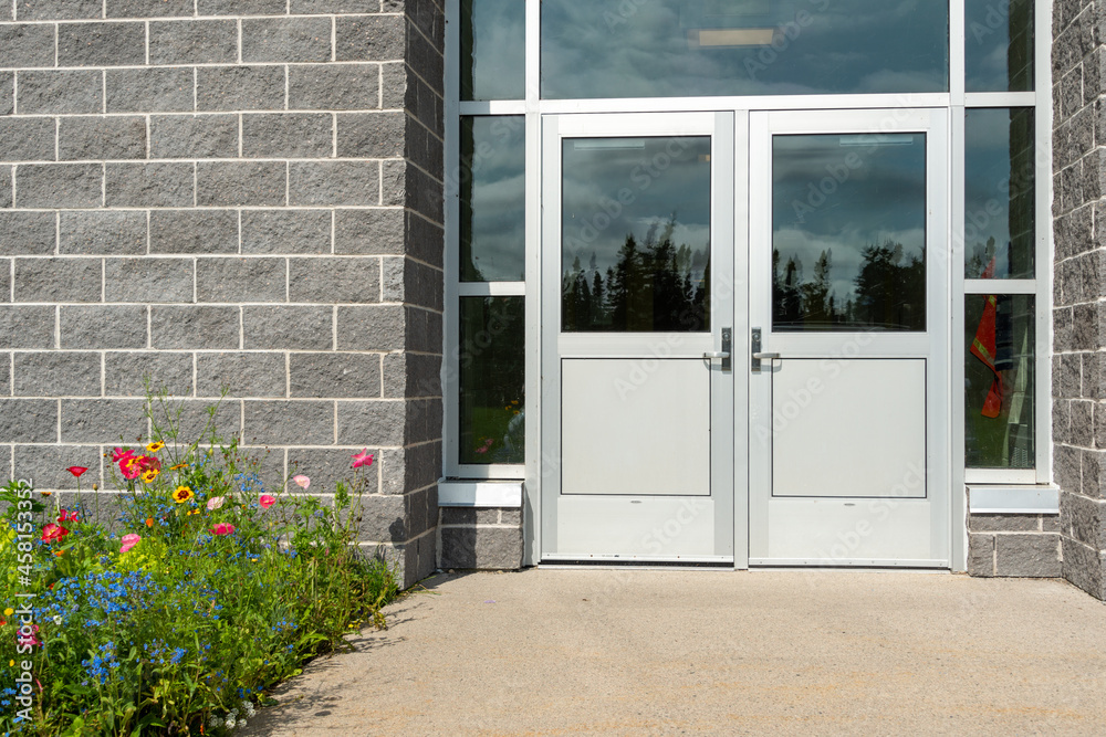 Double commercial exterior doors of a business. The glass is on top