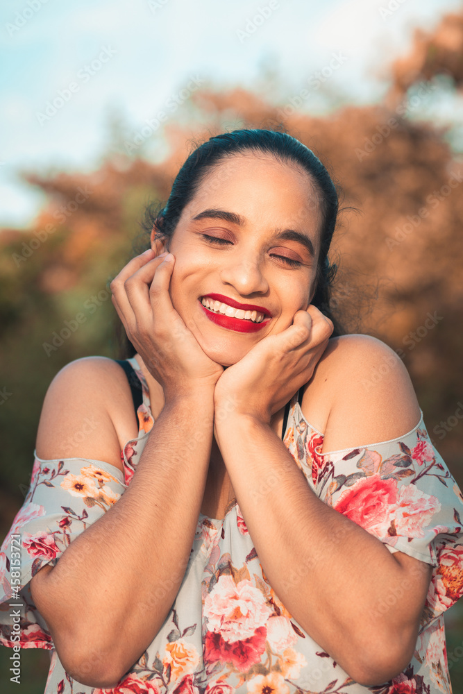 Latin woman with her face in her hands very happy Latin woman with her face in her hands very happy