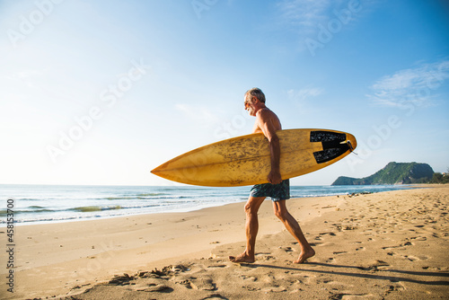 Mature surfer ready to catch a wave