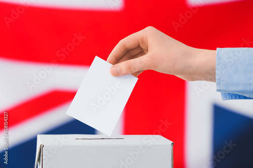 Woman voting against the flag of Great Britain, closeup
