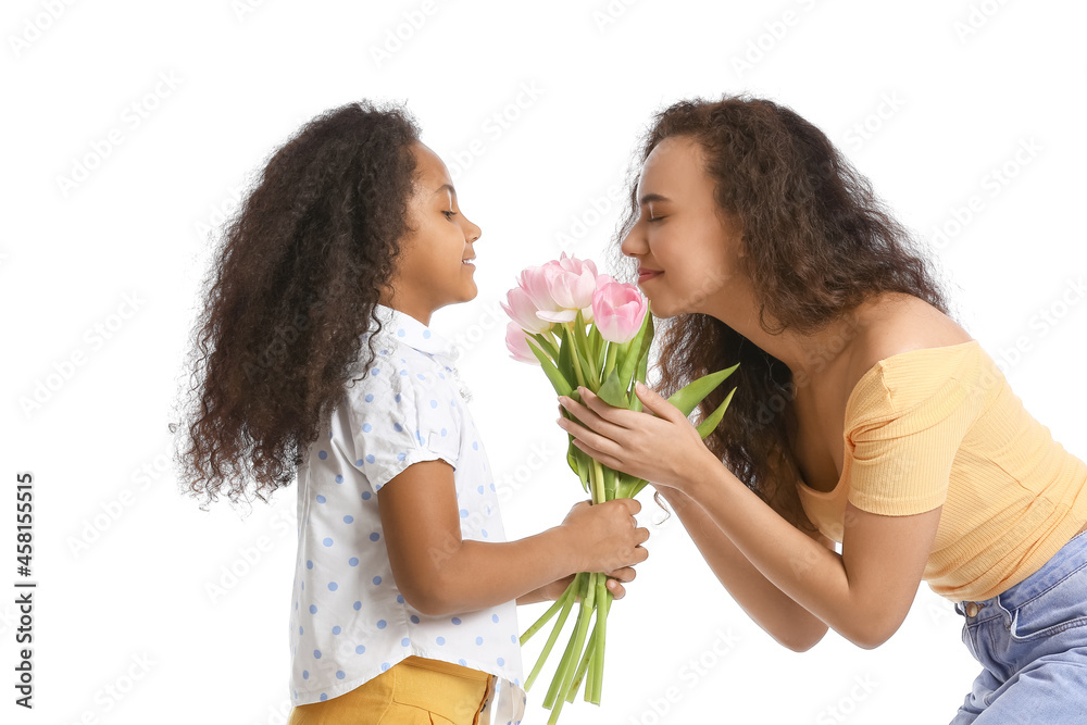 African-American little girl with her mother and bouquet of tulips on white background African-American little girl with her mother and bouquet of tulips on white background