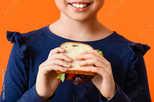 Little girl with tasty sand...