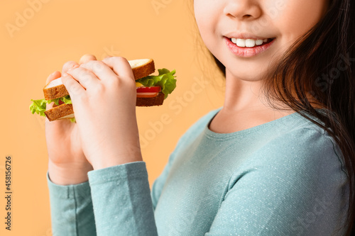 Little girl with tasty sand...