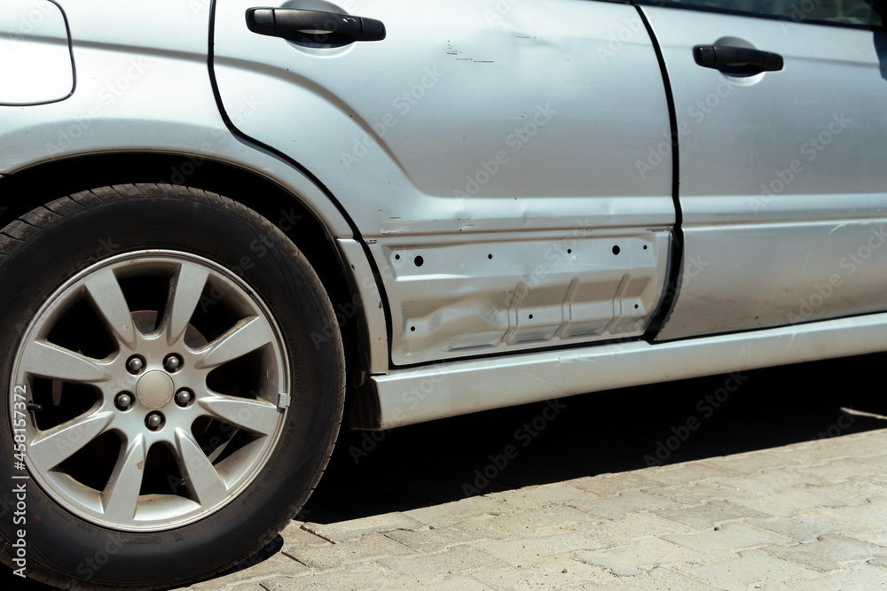 Damaged car, a damaged car waiting for a tow truck by the roadside.