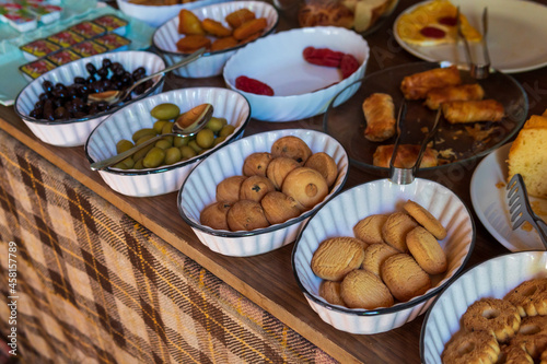 Buffet, a modest breakfast buffet, a table of cookies, olives and pastries.