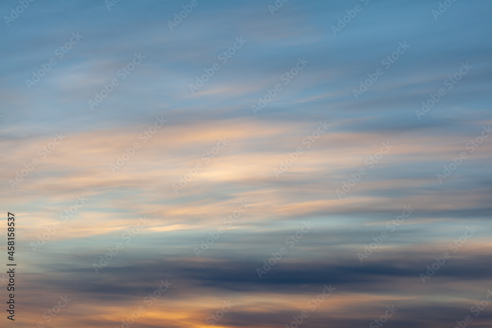 Colorful sunset or sunrise in the sky. The sky and clouds are painted in different delicate colors.