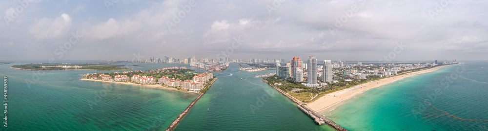 Beautiful aerial panorama over the Government Cut shipping channel looking towards Miami with Fisher Island and Miami Beach and miles of sandy beaches lining the turquoise waters of the Atlantic Ocean