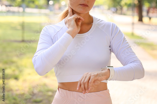 Female runner checking puls...