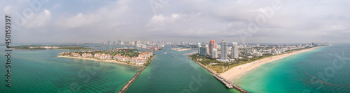 Beautiful aerial panorama over the Government Cut shipping channel looking towards Miami with Fisher Island and Miami Beach and miles of sandy beaches lining the turquoise waters of the Atlantic Ocean