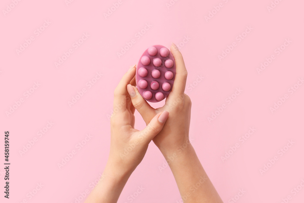 Female hands with massage soap bar on color background - obrazy, fototapety, plakaty 