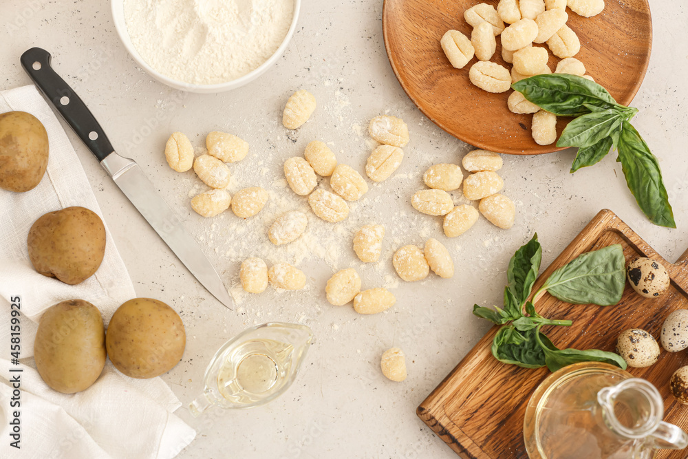 Composition with raw gnocchi on light background