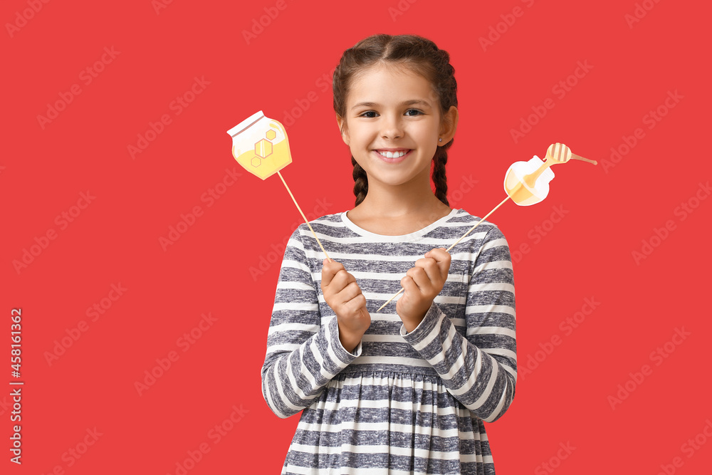 Little girl with decor for Rosh Hashanah (Jewish New Year) on color background Little girl with decor for Rosh Hashanah (Jewish New Year) on color background