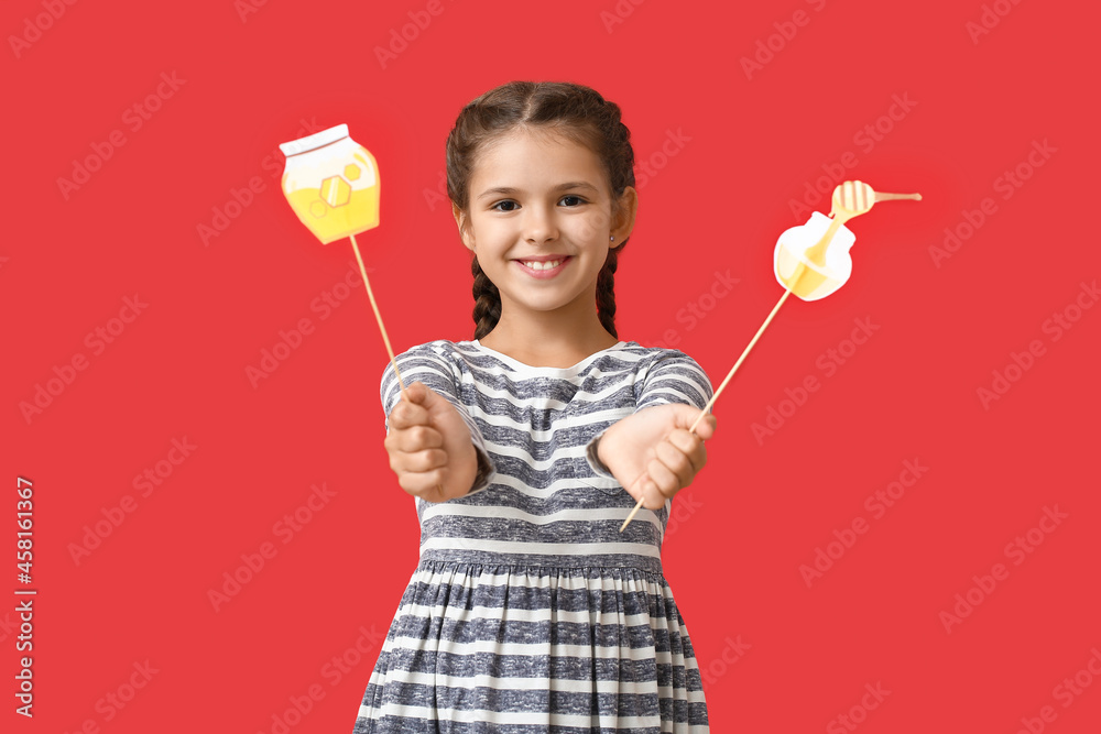 Little girl with decor for Rosh Hashanah (Jewish New Year) on color background Little girl with decor for Rosh Hashanah (Jewish New Year) on color background