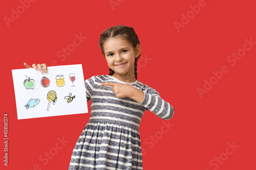 Little girl holding paper w...