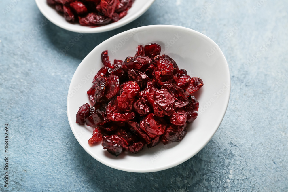 Plate with tasty dried cranberries on color background, closeup Plate with tasty dried cranberries on color background, closeup