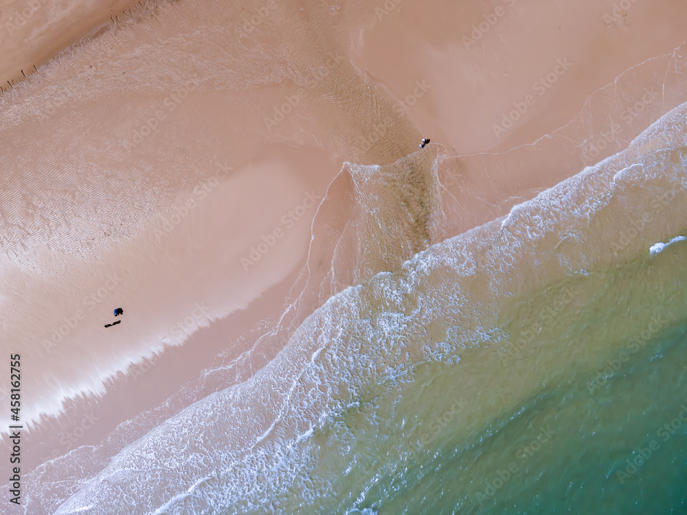 Fototapeta premium Aerial view of sandy beach and ocean with waves