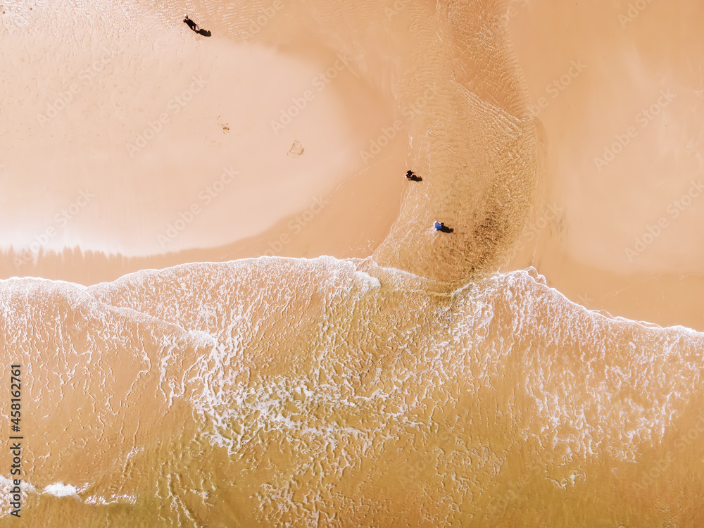 Fototapeta premium Aerial view of sandy beach and ocean with waves