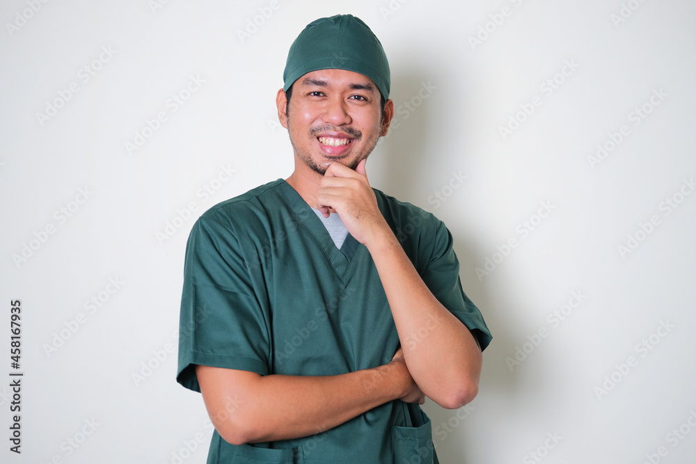 Asian hospital nurse man standing confident with hand touching chin