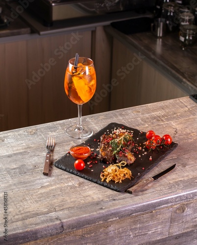 Wineglass and steak with vegetables in restaurant