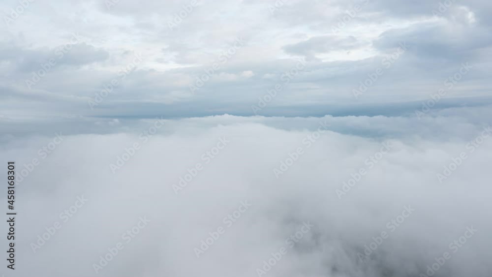 B-roll of Hyperlapse timelapse drone flying above white clouds dense fog move quickly. Hyper lapse fluffy clouds foggy. Fog sea. Aerial time lapse drone fly touching moving fog sea after rainy. B-roll of Hyperlapse timelapse drone flying above white clouds dense fog move quickly. Hyper lapse fluffy clouds foggy. Fog sea. Aerial time lapse drone fly touching moving fog sea after rainy.