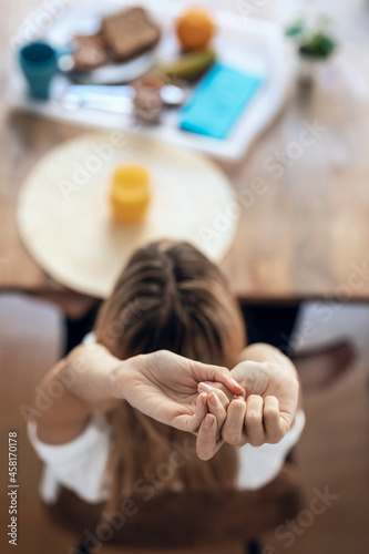 Wallpaper Mural Beautiful woman having healthy breakfast while streching sitting in the living room at home. Torontodigital.ca