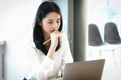 Female employees are working at home through computers to maintain social distancing to reduce the spread of coronavirus.