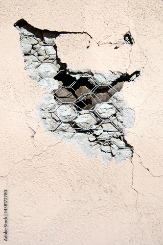 Фотография Damaged stucco wall finish close-up