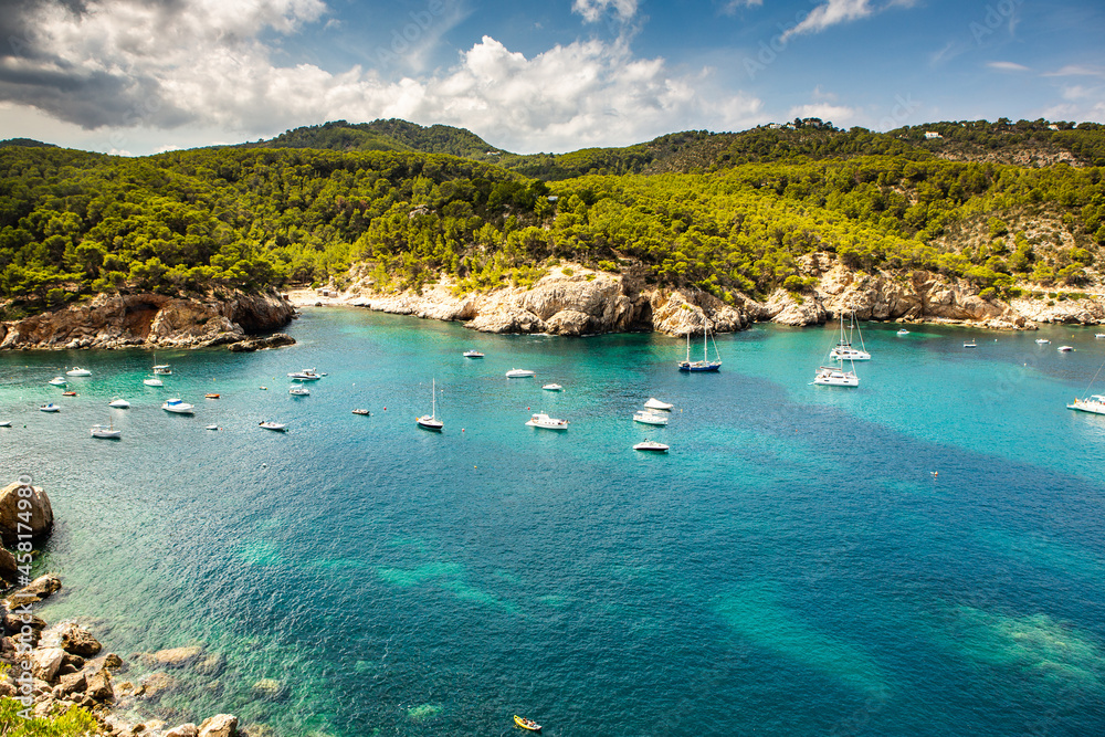 Obraz premium Beautiful beach with very clean and azure water on the mediterranean sea in the island of Ibiza, Spain