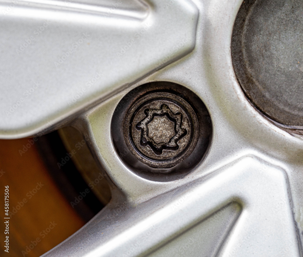 Obraz premium A secret bolt in a car wheel. Anti-theft protection, macro