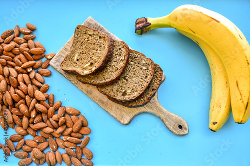 Keto banana  bread. Tasty Almond flour and banana  ketogenic buns, homemade with crust and sesame and  sunflower seeds  seeds on wooden board. photo