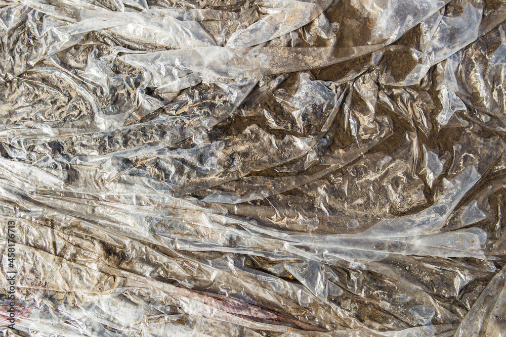 Gray plastic texture of wet cellophane. Abstract background Gray plastic texture of wet cellophane. Abstract background