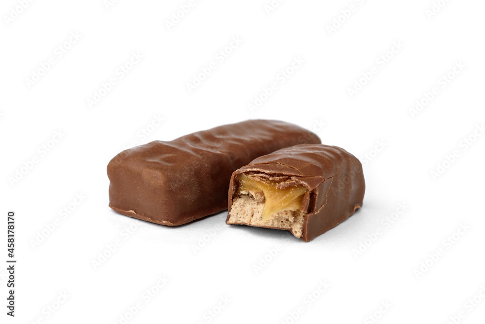 Broken chocolate bar with nougat and caramel isolated on white background. Broken chocolate bar with nougat and caramel isolated on white background.