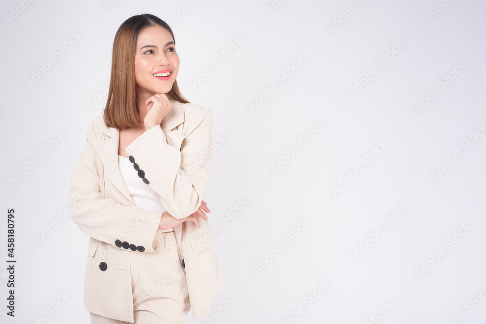Portrait of young beautiful businesswoman wearing suit in white background studio.. Portrait of young beautiful businesswoman wearing suit in white background studio..