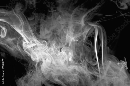 Abstract image of a cloud of thick white smoke on a black background.
