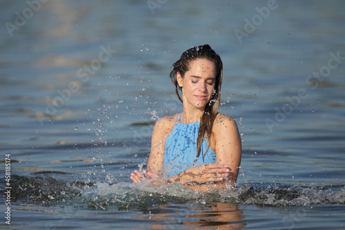 Fototapeta Naklejka Na Ścianę i Meble -  young woman in the water in a dress