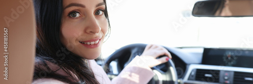 Portrait of smiling woman driver in car salon
