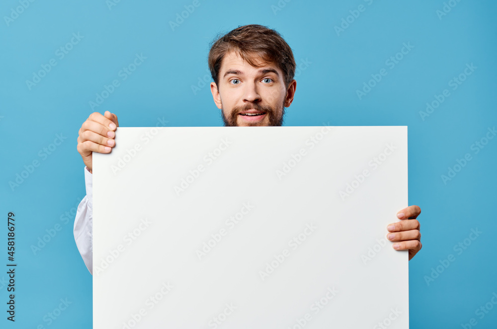 emotional man White mockup poster in hand advertising blue background emotional man White mockup poster in hand advertising blue background