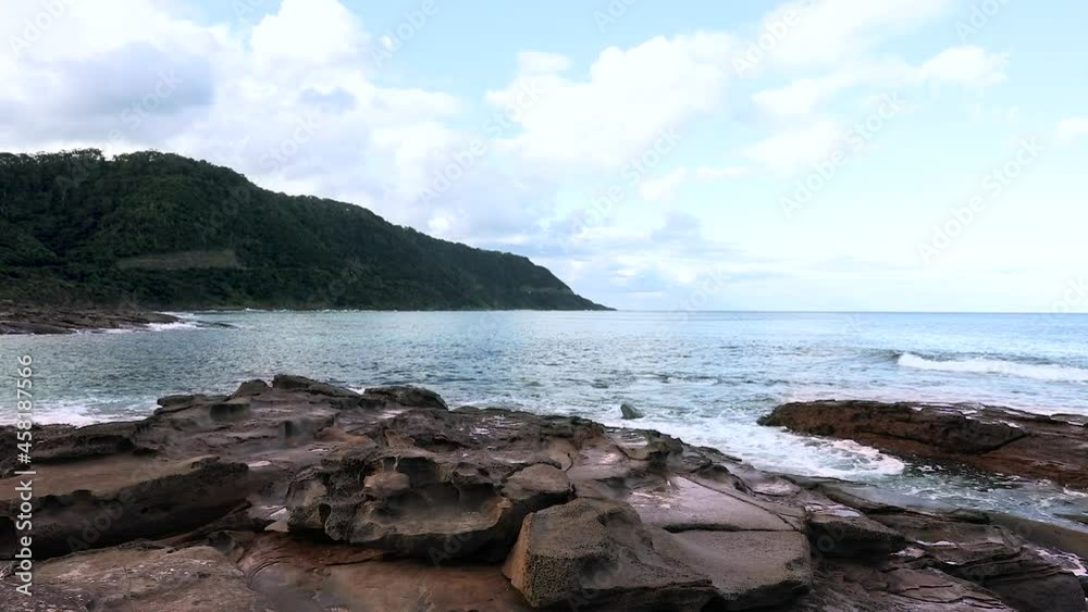 Peaceful ocean seaside view, waves lapping around rocks. Peaceful ocean seaside view, waves lapping around rocks.