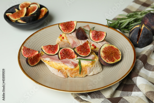 Concept of tasty food with bruschetta with fig on white background