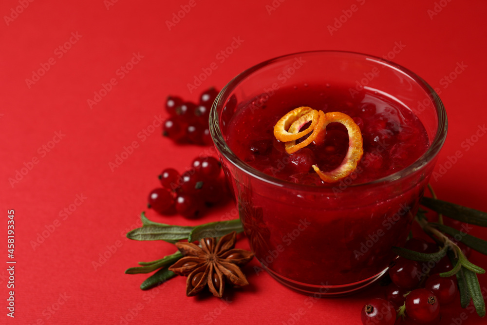 Cranberry sauce and ingredients on red background Cranberry sauce and ingredients on red background