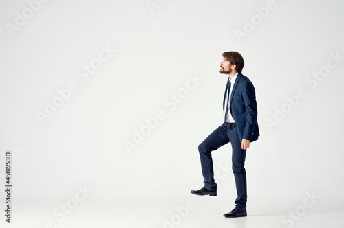 man in a jacket and tie posing executive light background © SHOTPRIME STUDIO