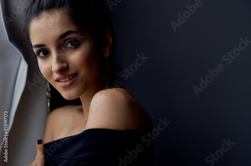 brunette near window posing attractive look earrings fashion model