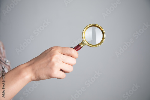 The woman holding magnifying glass